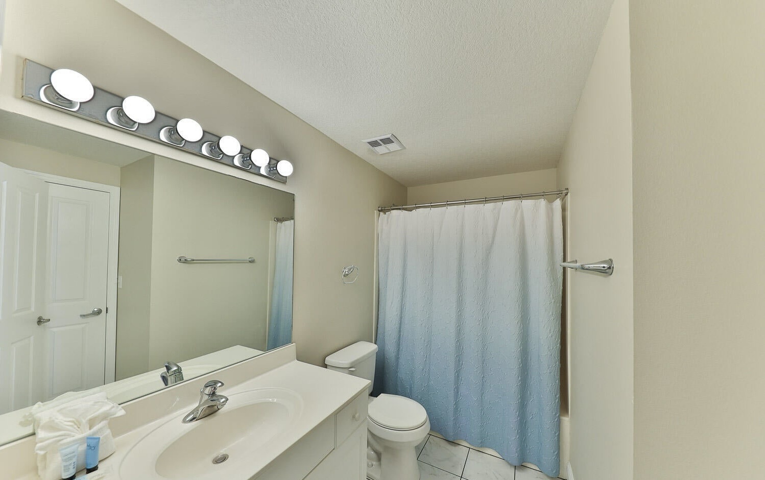 Secondary guest bathroom with shower and tub combo