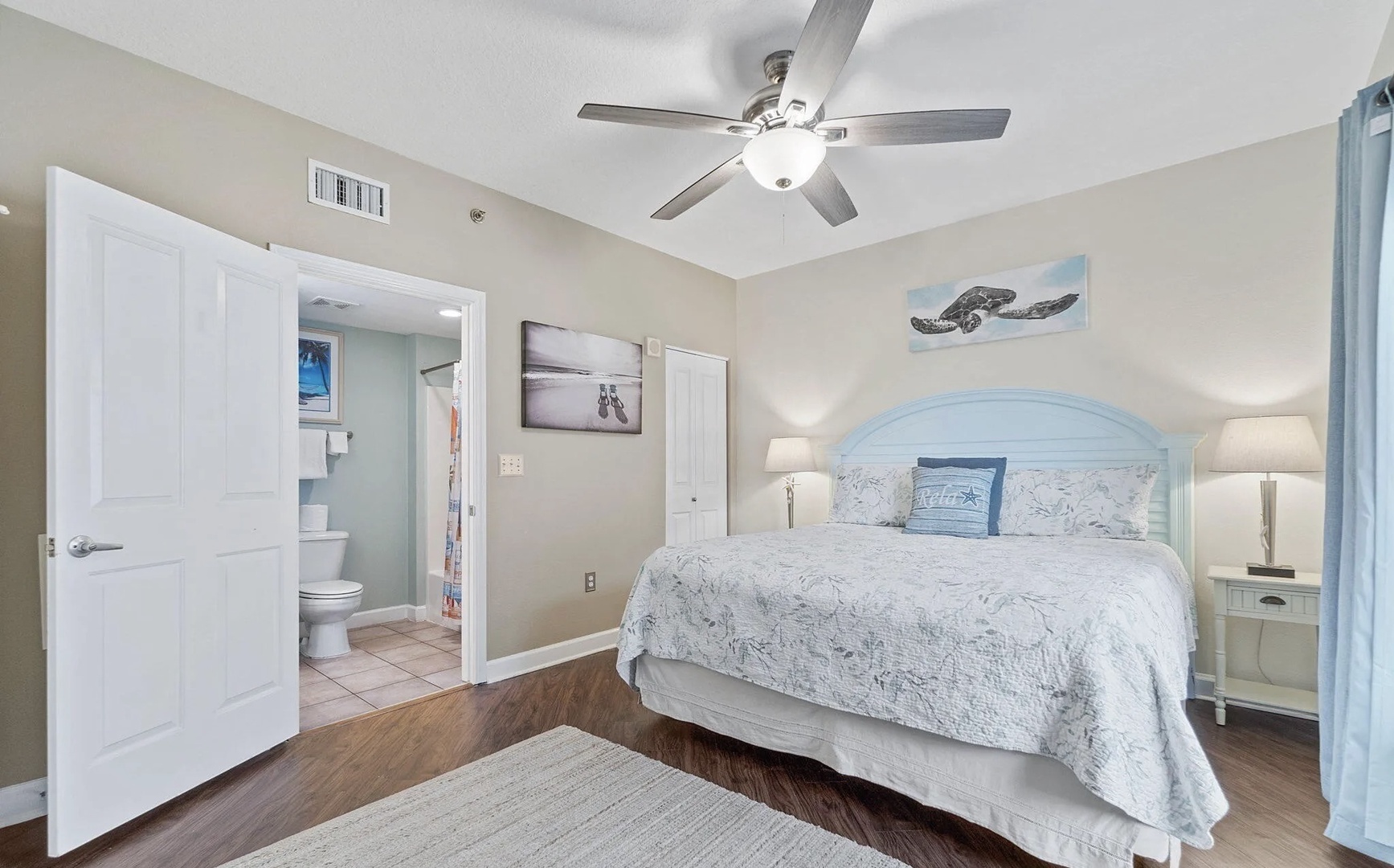 Primary bedroom with king bed, TV, and scenic views. Features an ensuite bathroom.