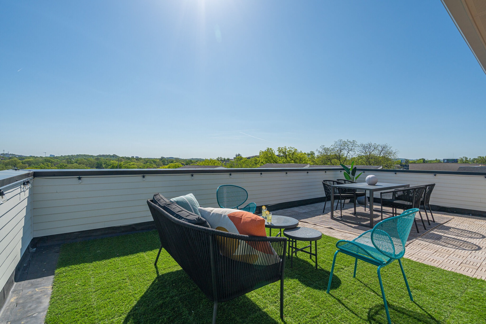Private rooftop deck outdoor dining table (seats 4) and lounge area. Entire space is lined with bistro lights and includes a photo op mural!