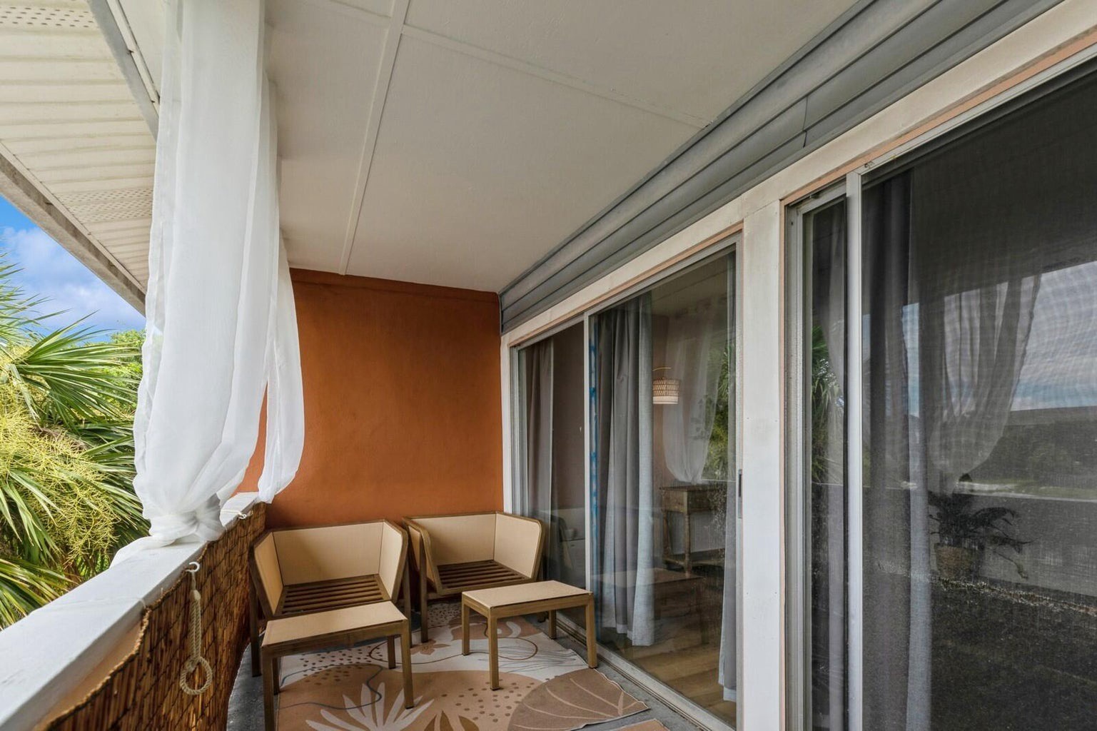 Private balcony with seating and blinds