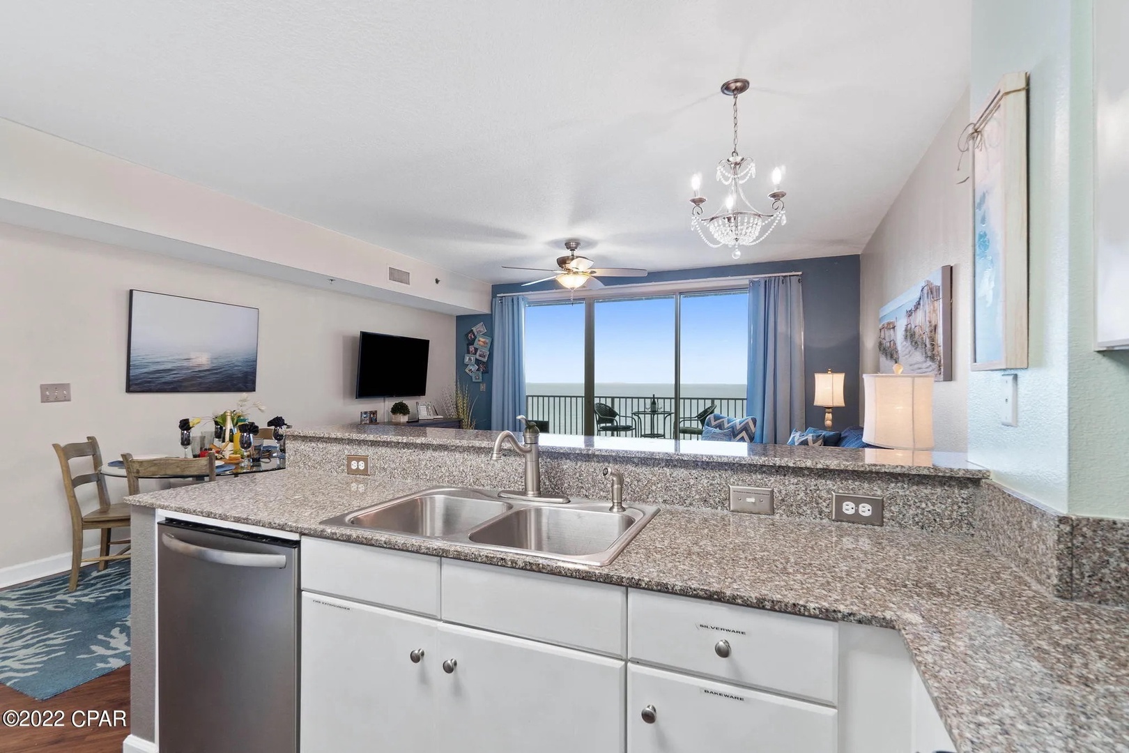 Full kitchen with stainless steel appliances and equipped with basic cooking essentials.
