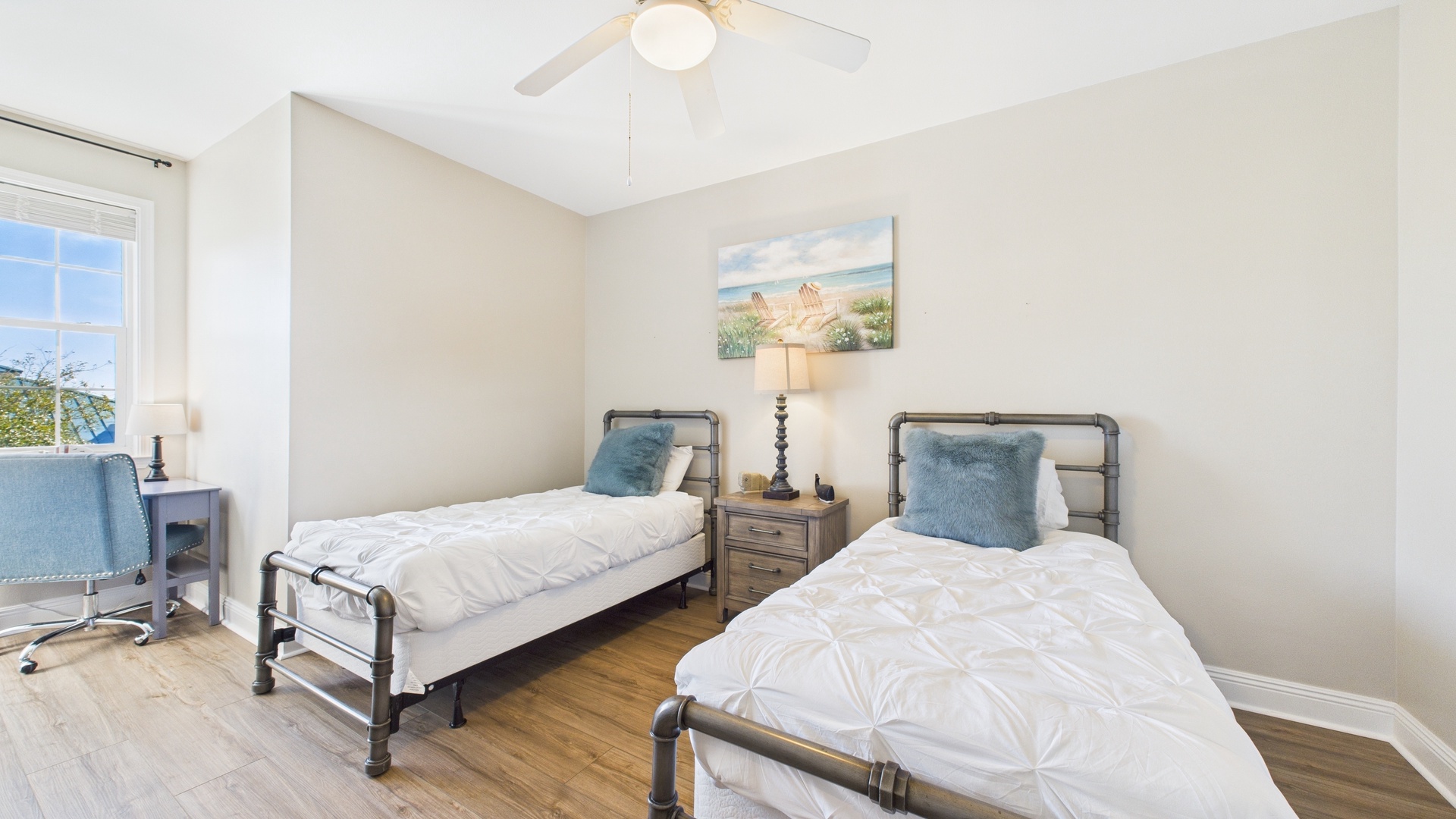 Guest bedroom with two twin beds and desk