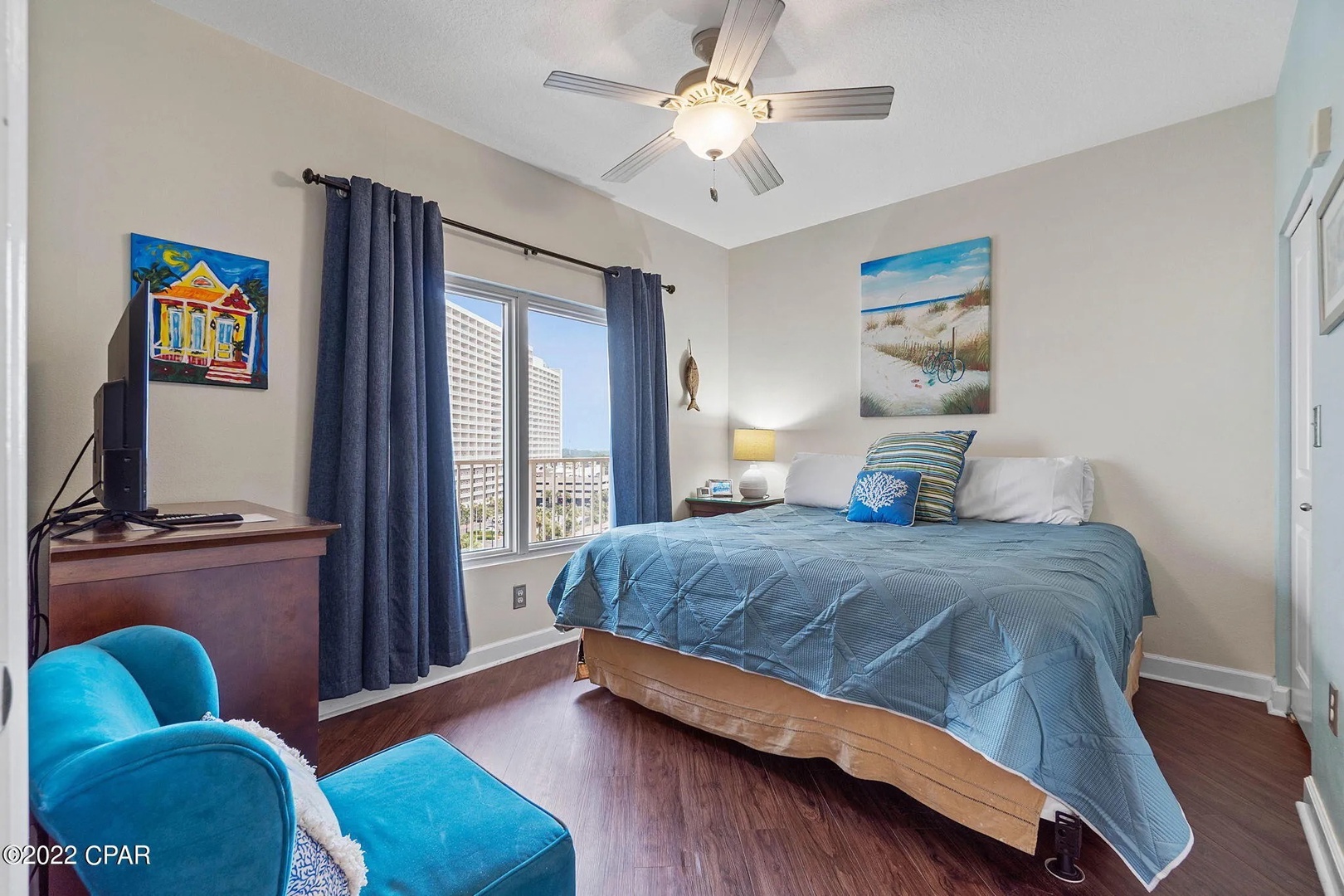 Second bedroom with king bed, TV, and scenic views.