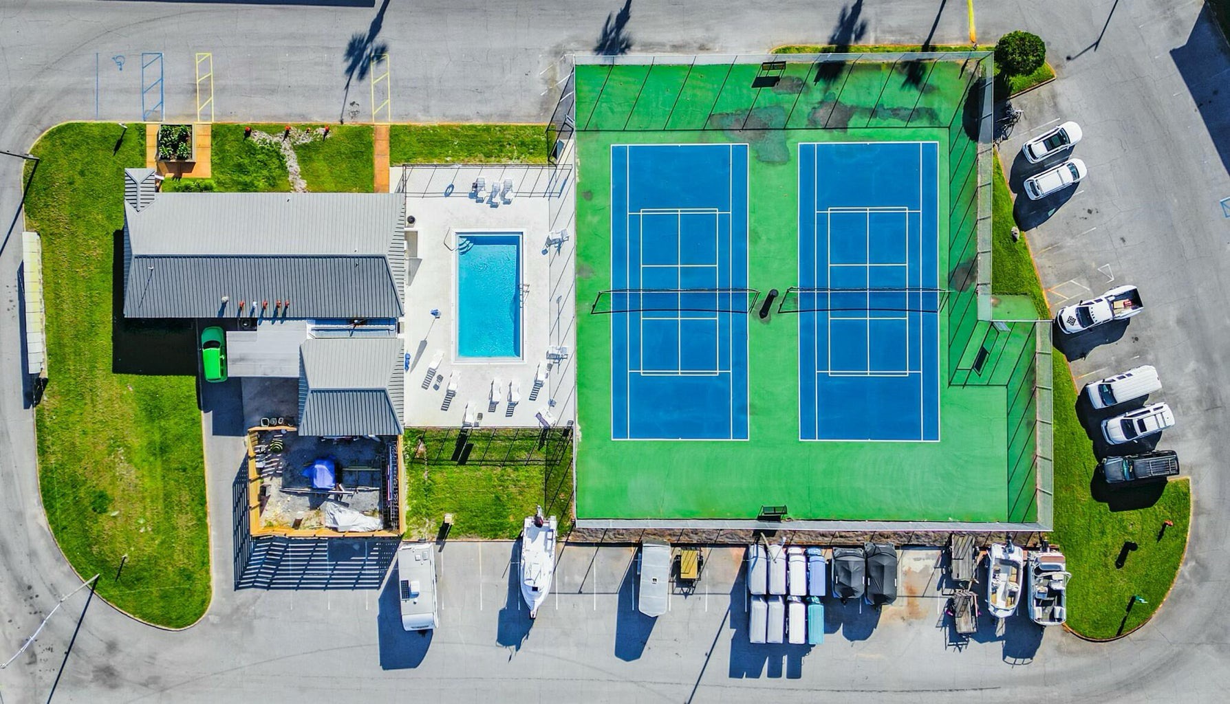 Aerial view of community pool and tennis courts