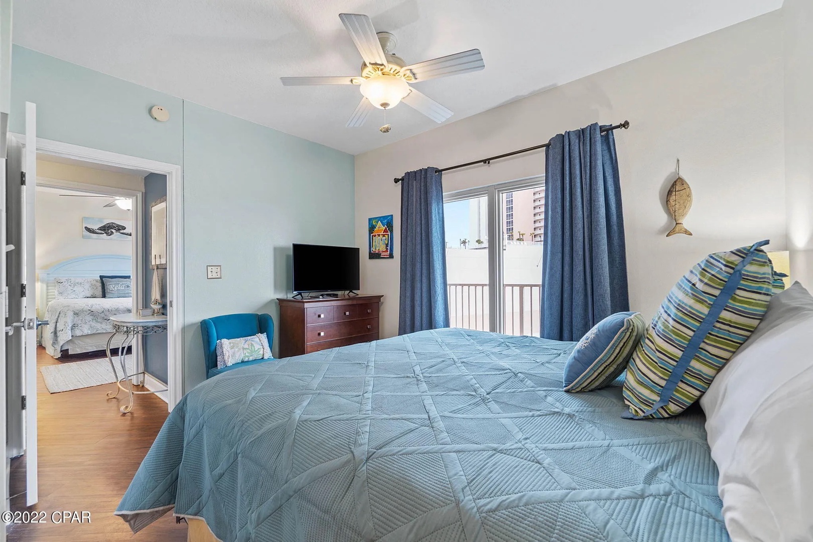 Second bedroom with king bed, TV, and scenic views. Features an ensuite bathroom.