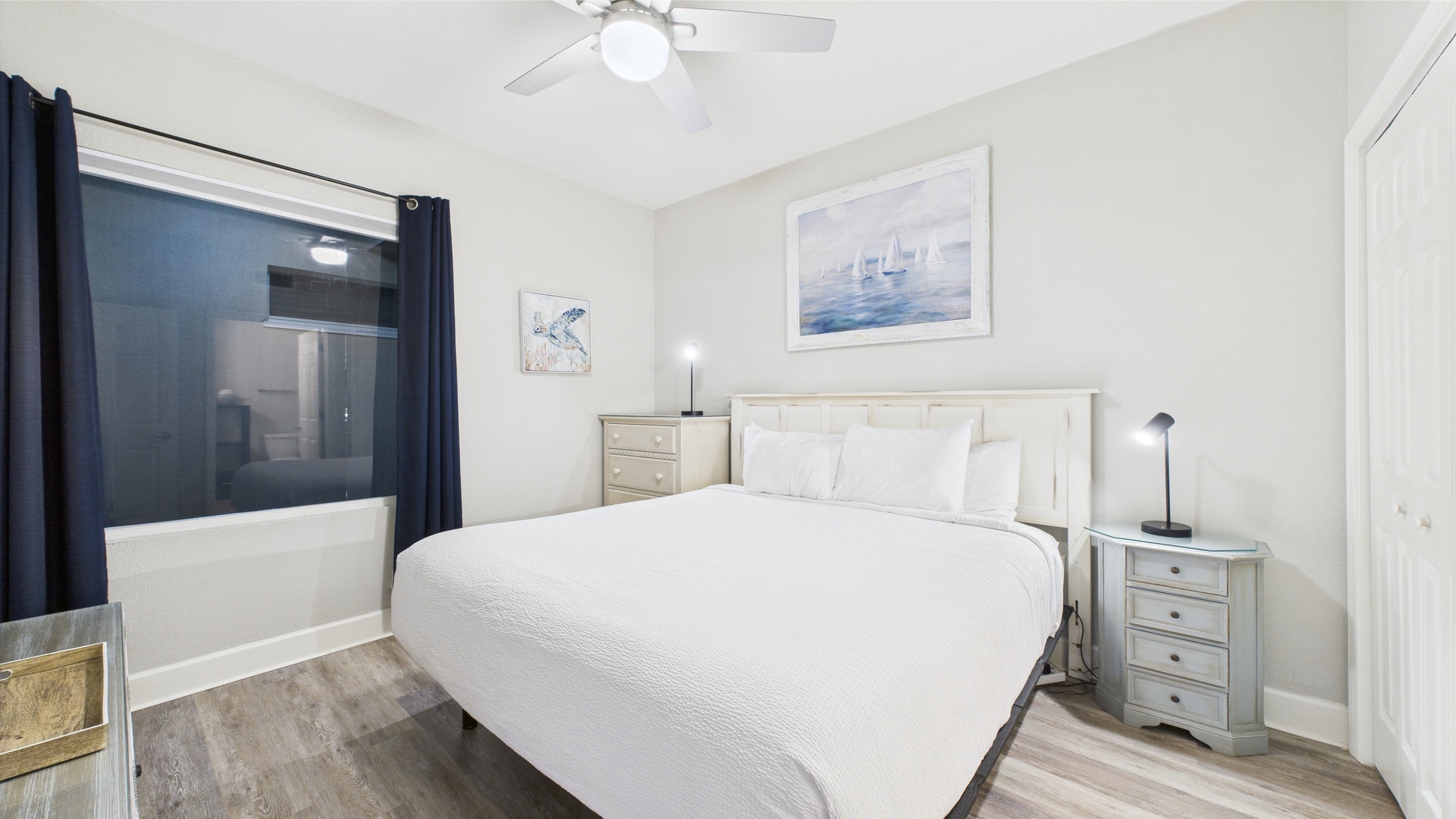 Master bedroom with king bed TV and ensuite bathroom