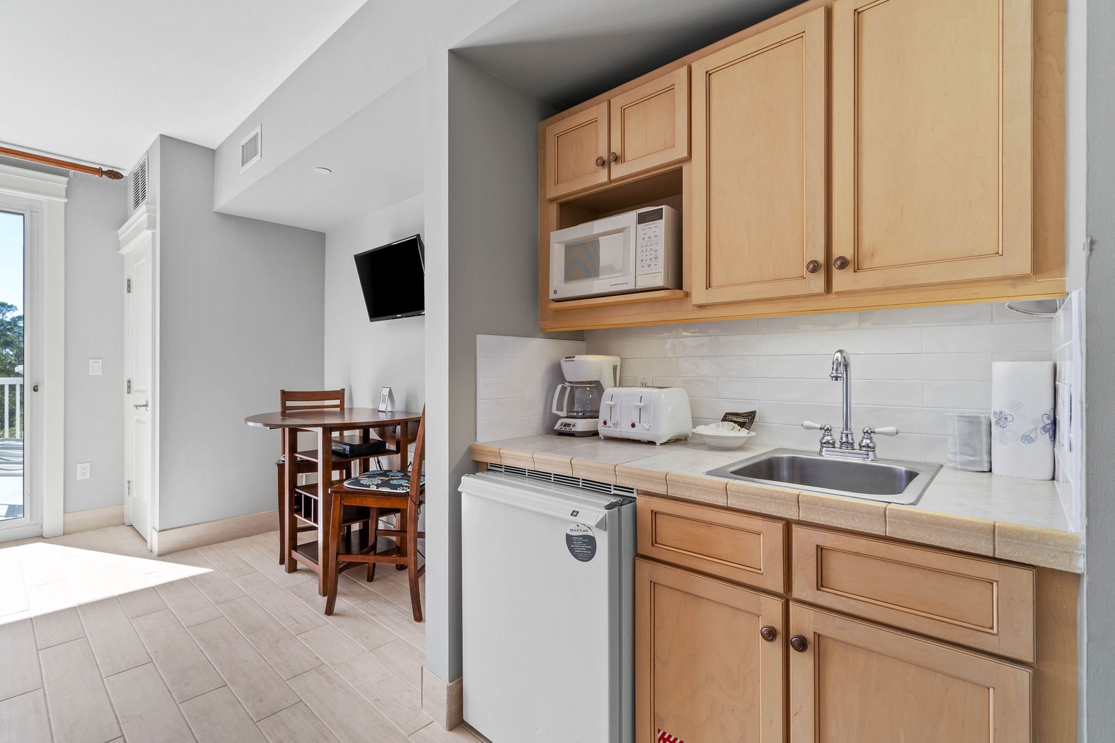 Kitchenette complete with sink, mini fridge, and microwave