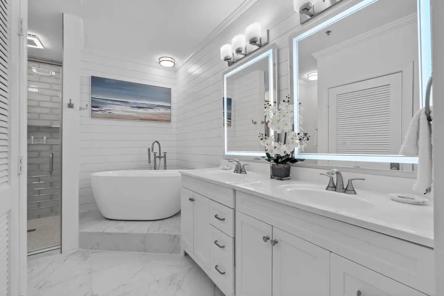 Primary bathroom with dual vanity bathtub and walk in shower