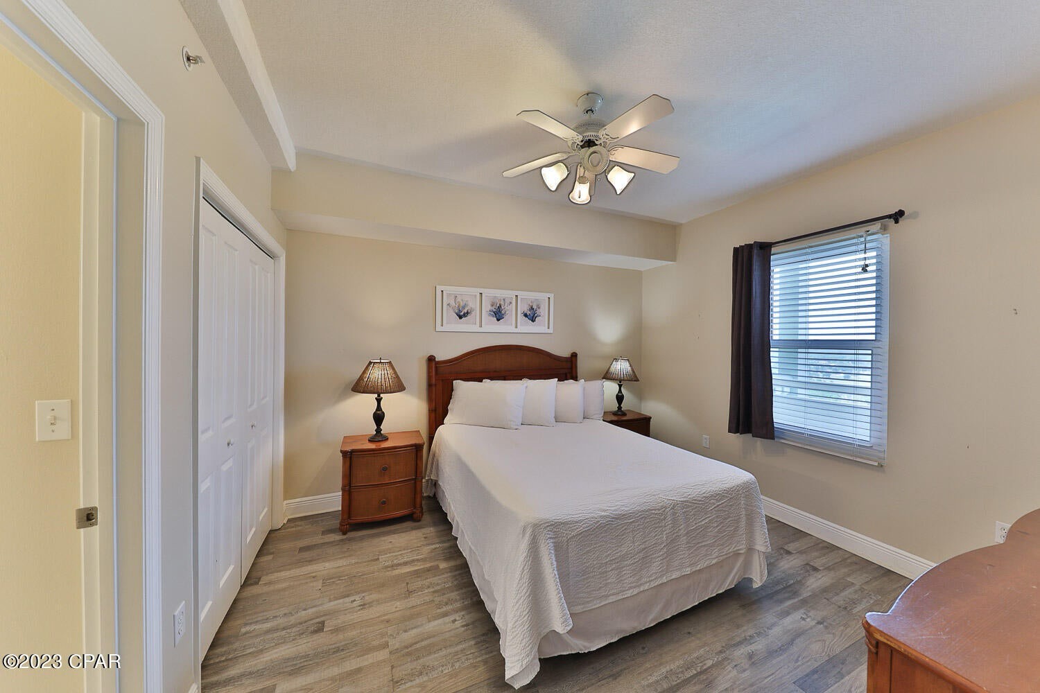 Primary guest bedroom with queen bed and walk in bathroom