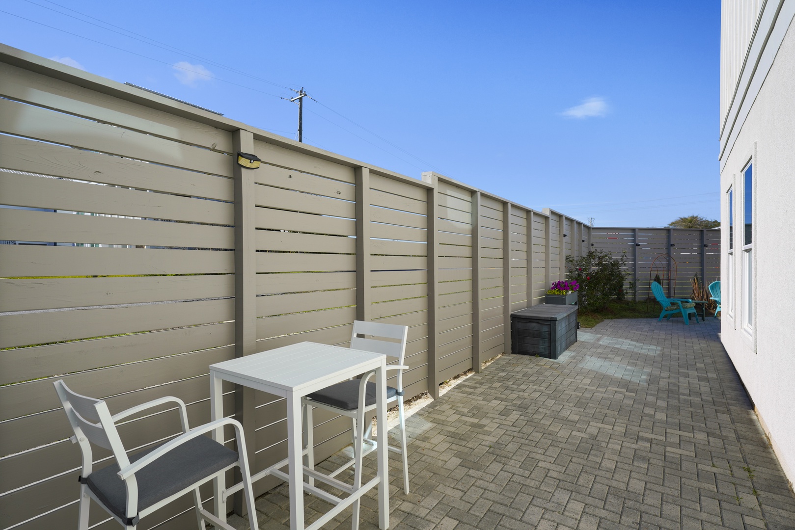 Fenced ground level deck by the pool fenced
