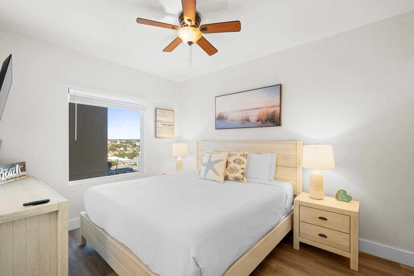Master bedroom with king bed TV and ensuite bathroom