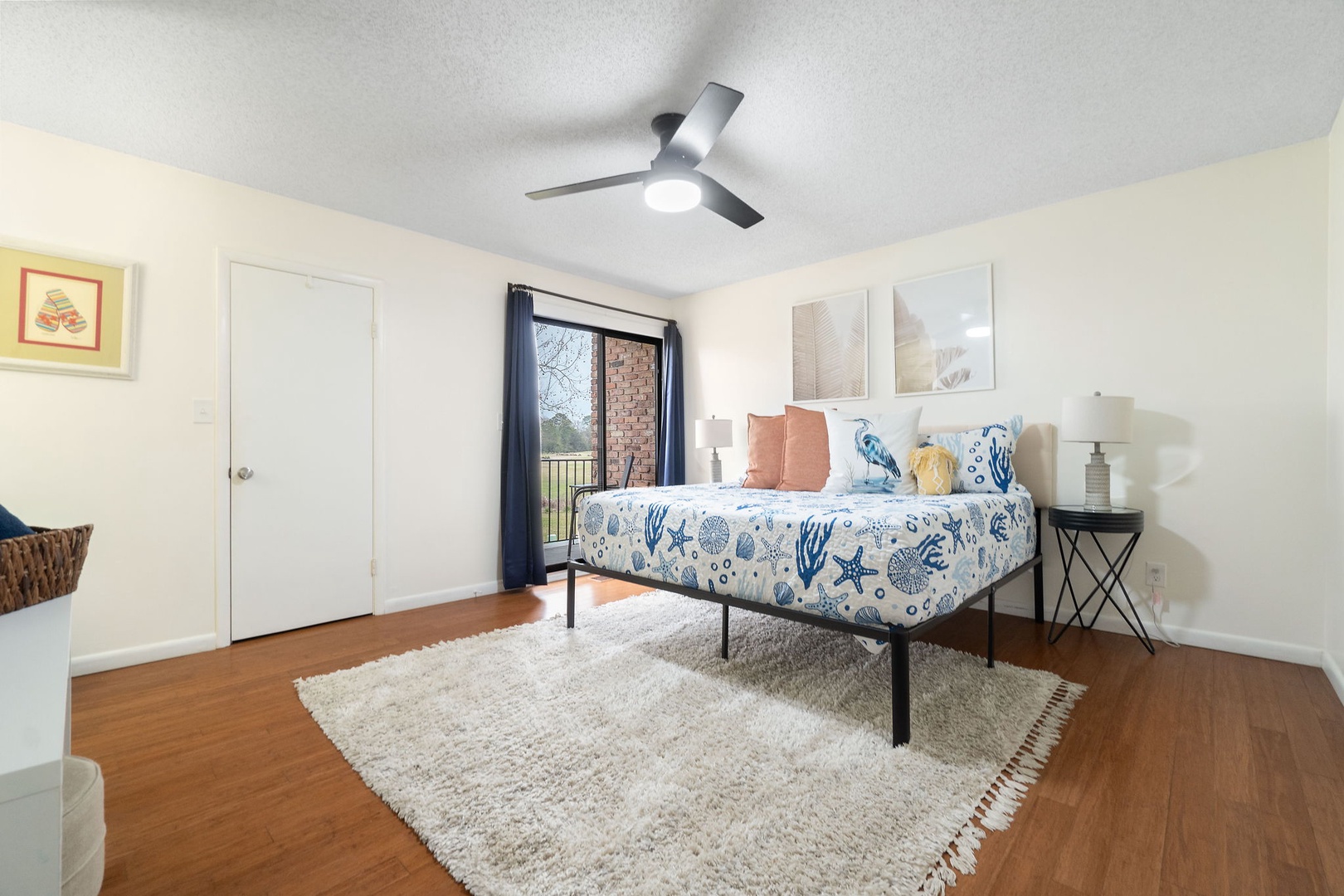 Primary bedroom with king bed TV and balcony access