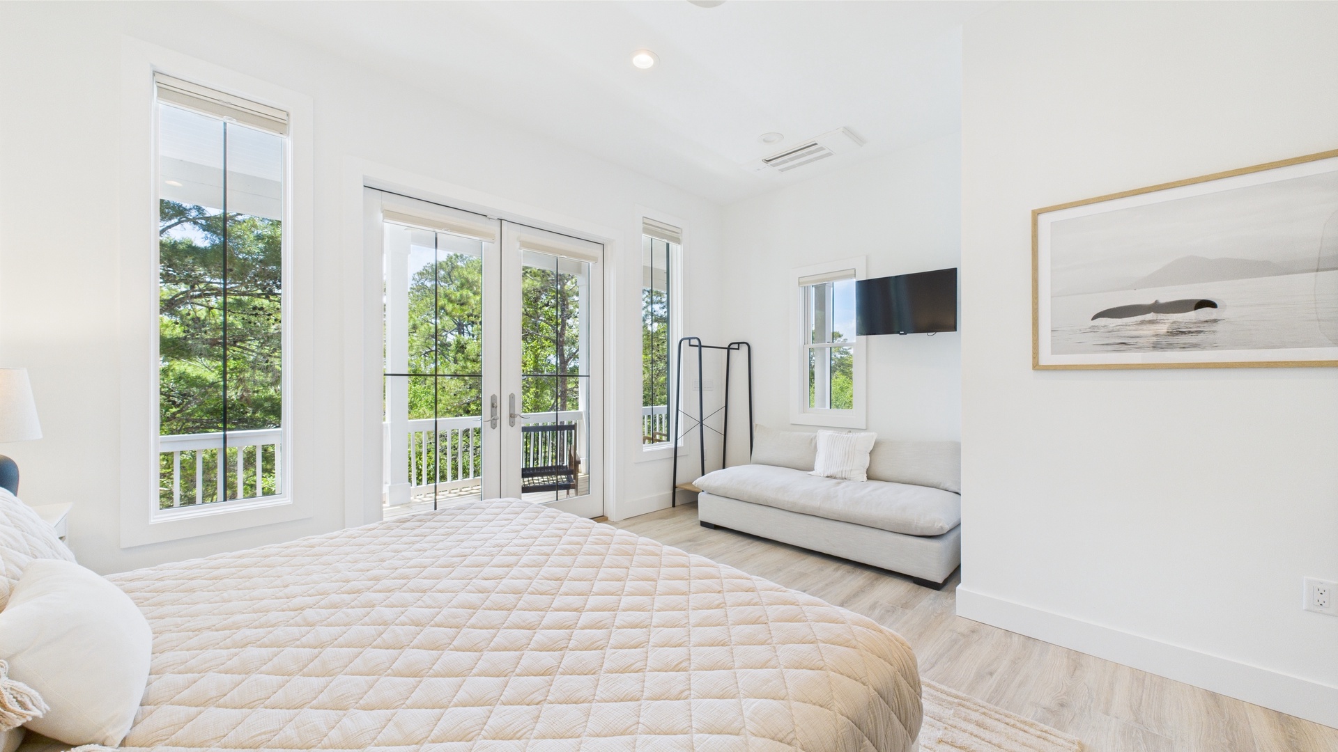 Master bedroom with king bed TV and ensuite bathroom
