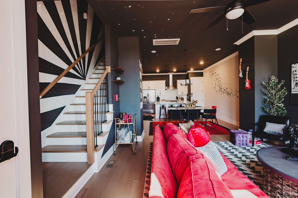 Open concept living area with stylish furnishings and TV