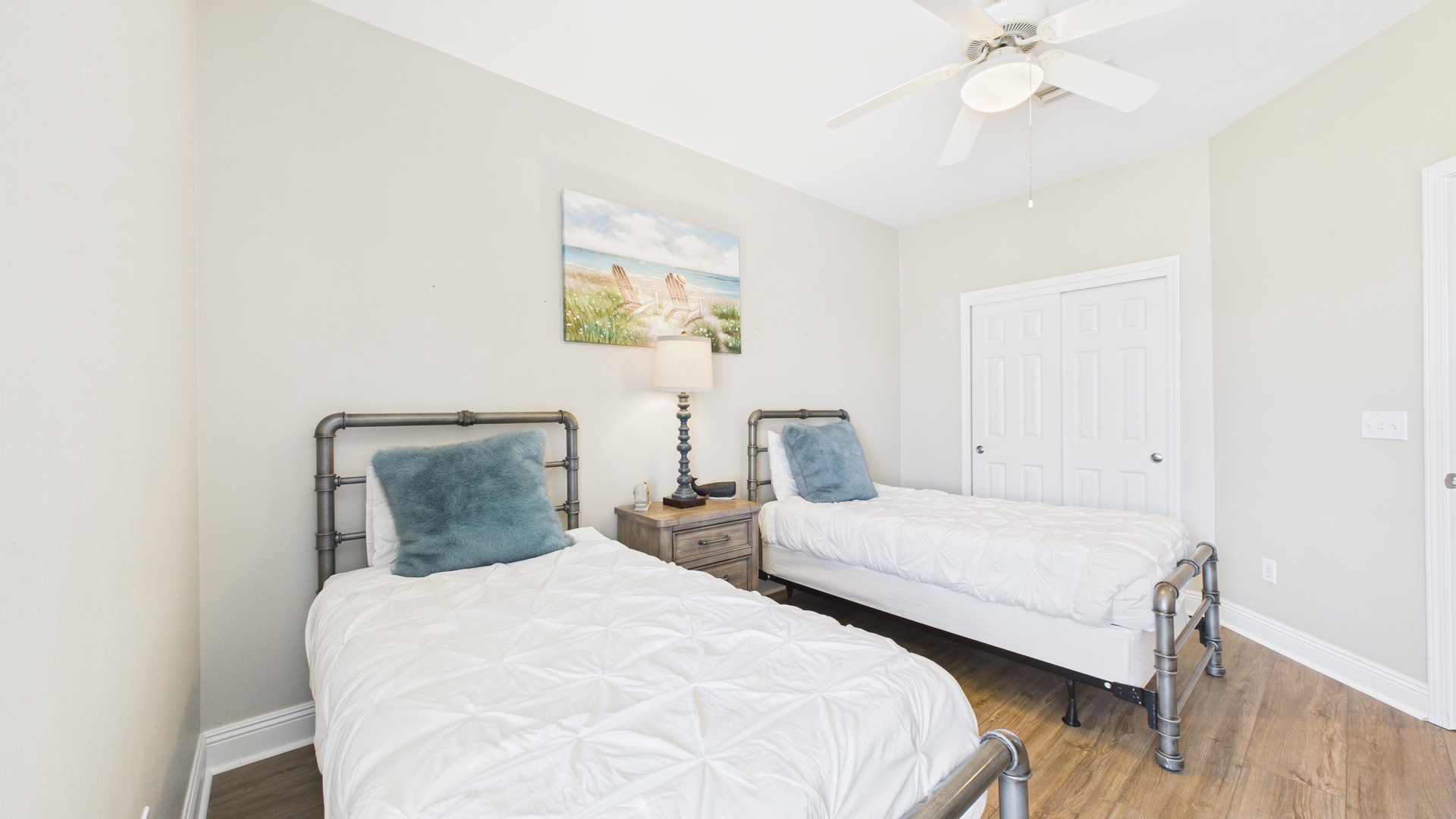 Guest bedroom with two twin beds and desk