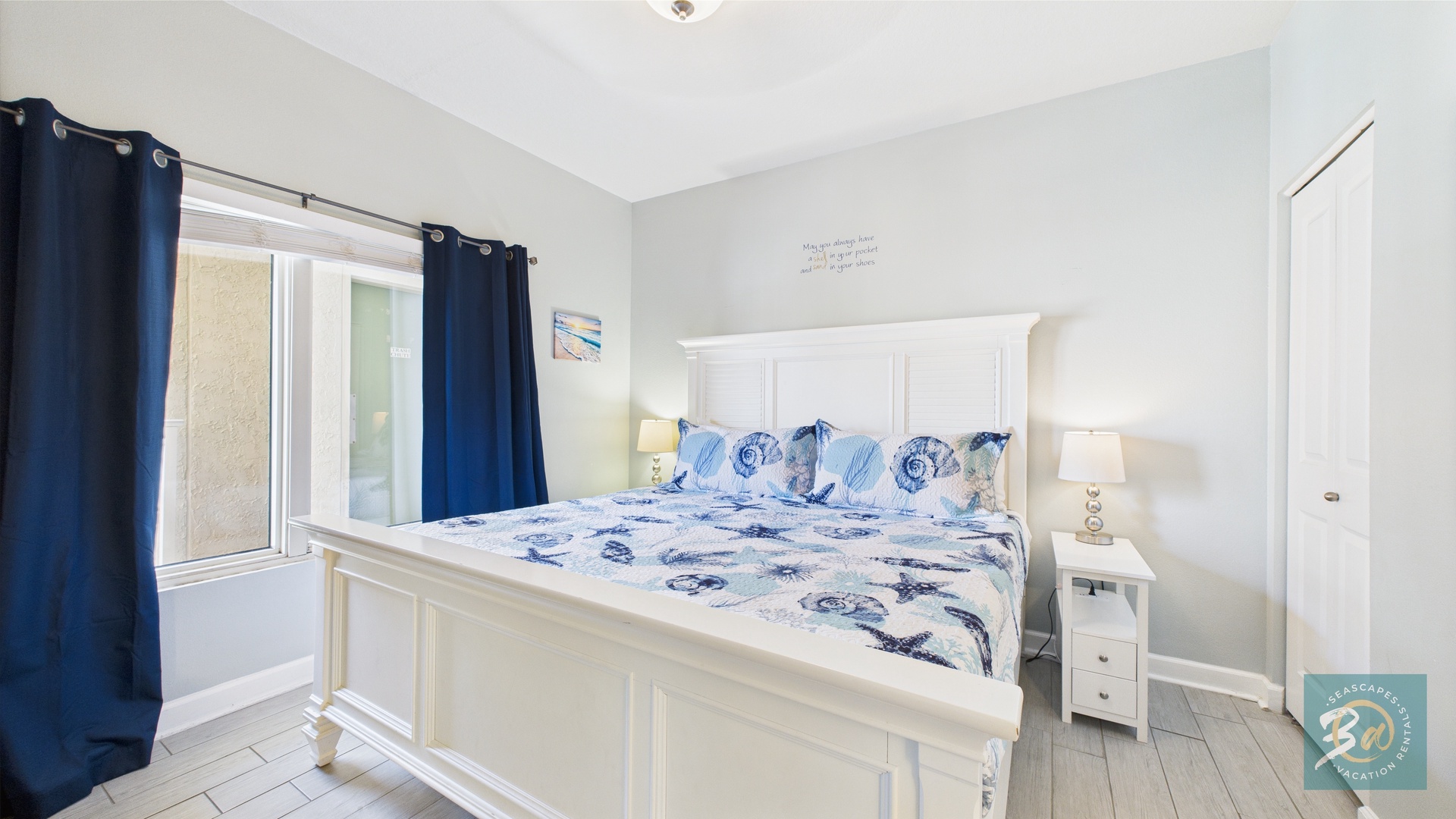 Master bedroom with king bed TV and ensuite bathroom