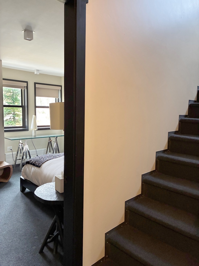 Step into your modern retreat where natural light spills through generous windows, highlighting the sleek workspace and comfortable bed. The contemporary design and clever layout create a space where you'll feel inspired and relaxed.