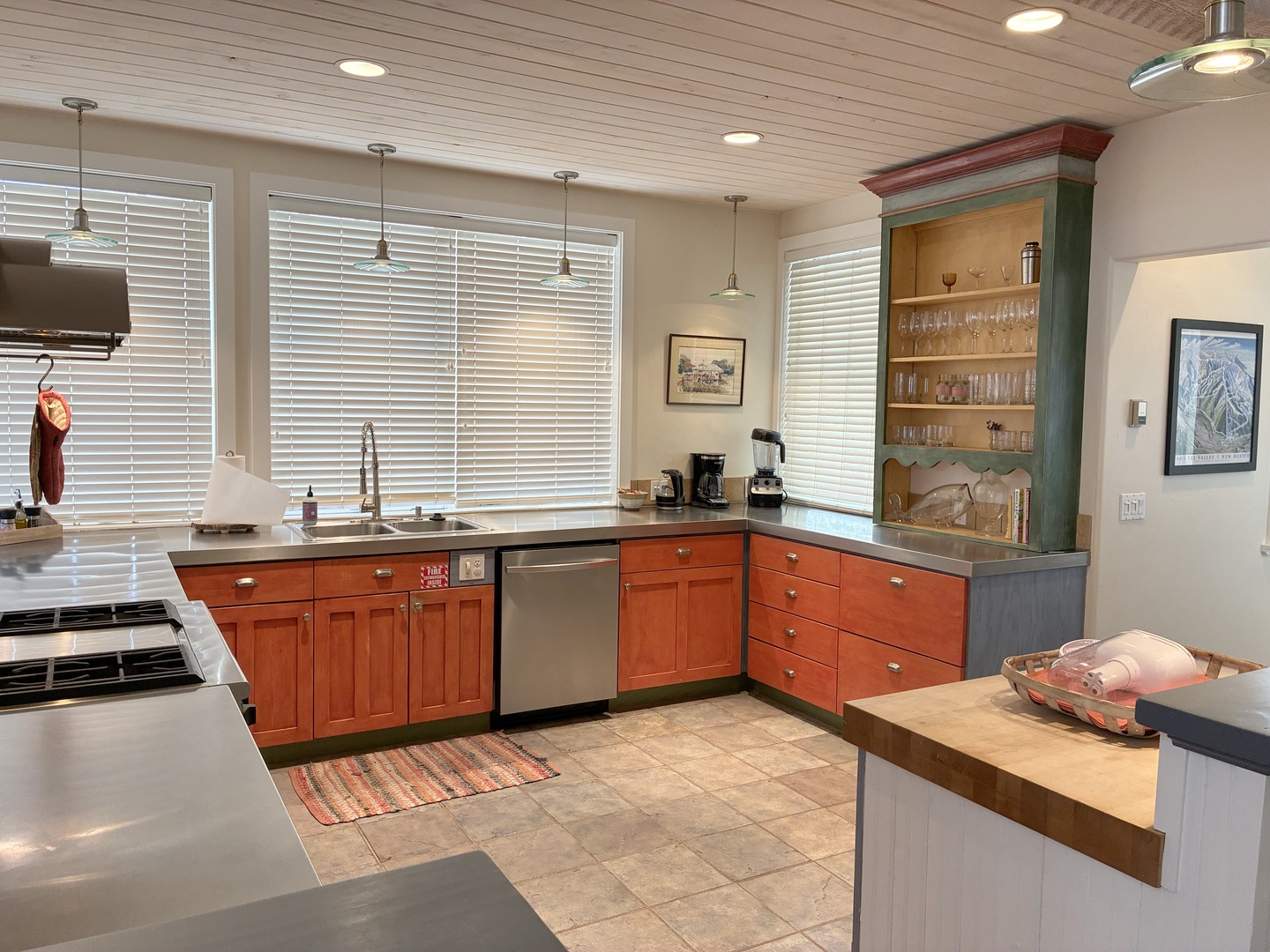 Whip up your favorite meals in this fully equipped kitchen featuring stainless appliances, ample counter space, and a charming built-in hutch perfect for morning coffee and evening gatherings.