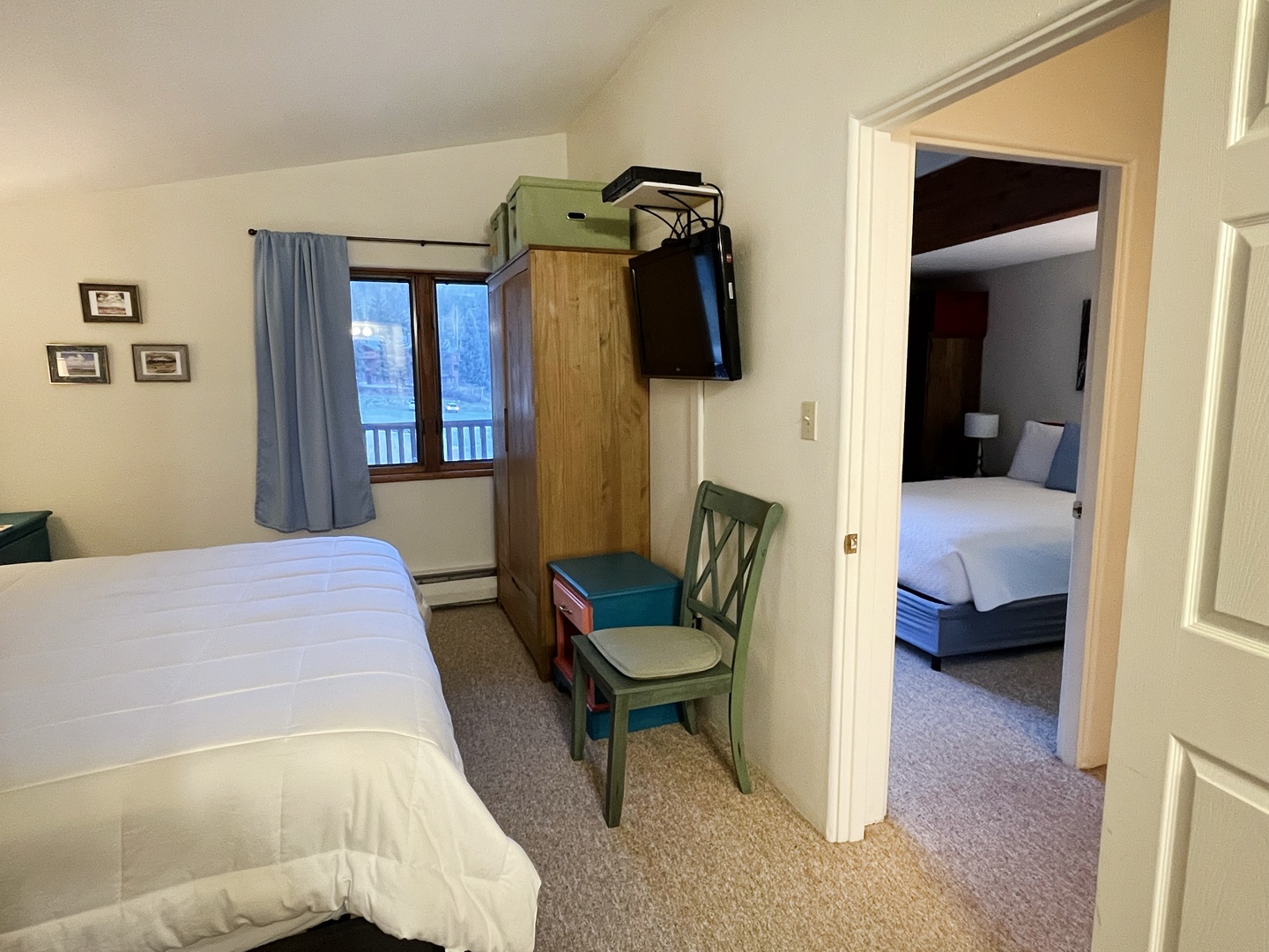 King bedroom storage and view into hallway to queen bedroom