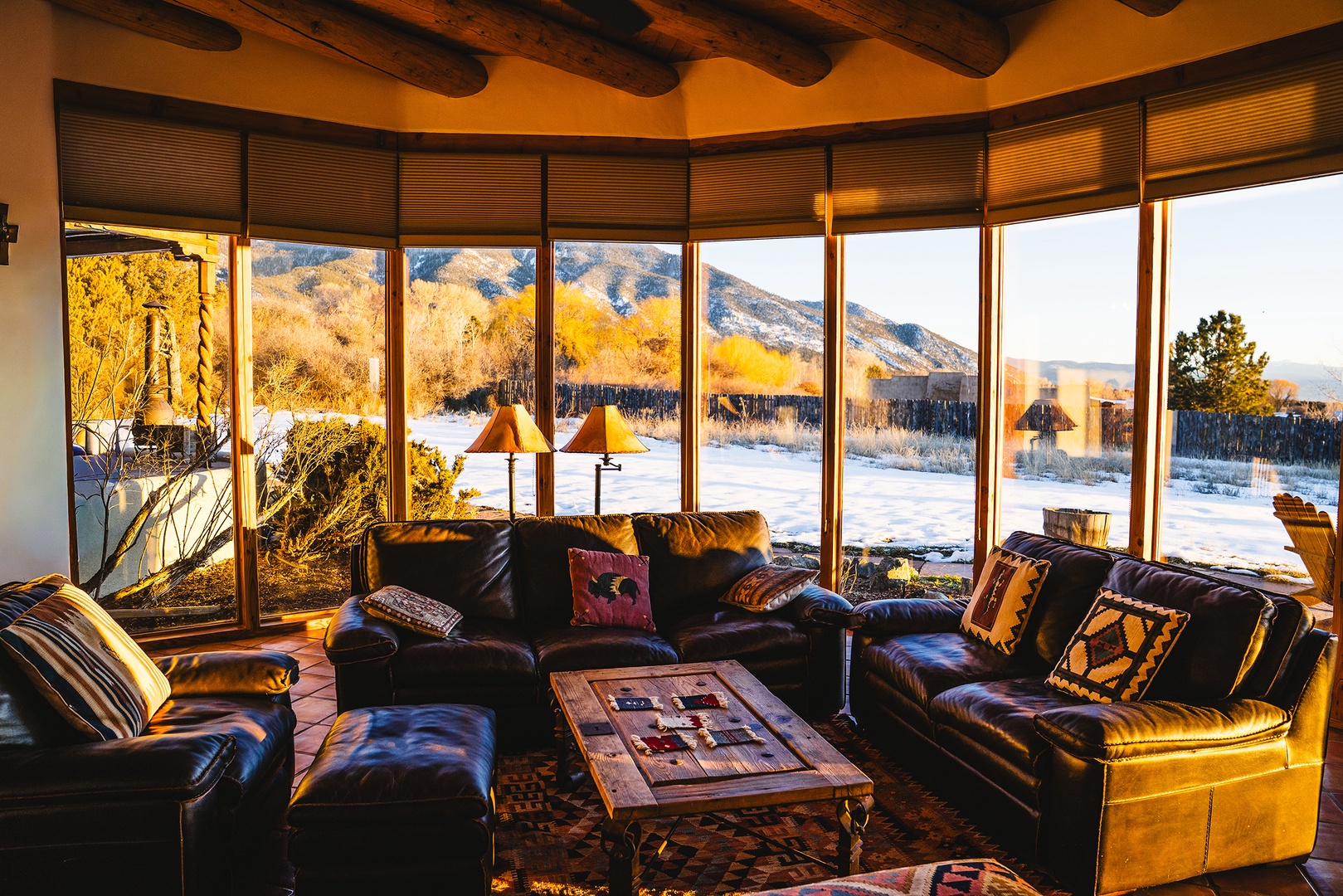 Sink into plush leather seating as you watch golden sunlight dance across snow-capped mountains through floor-to-ceiling windows.