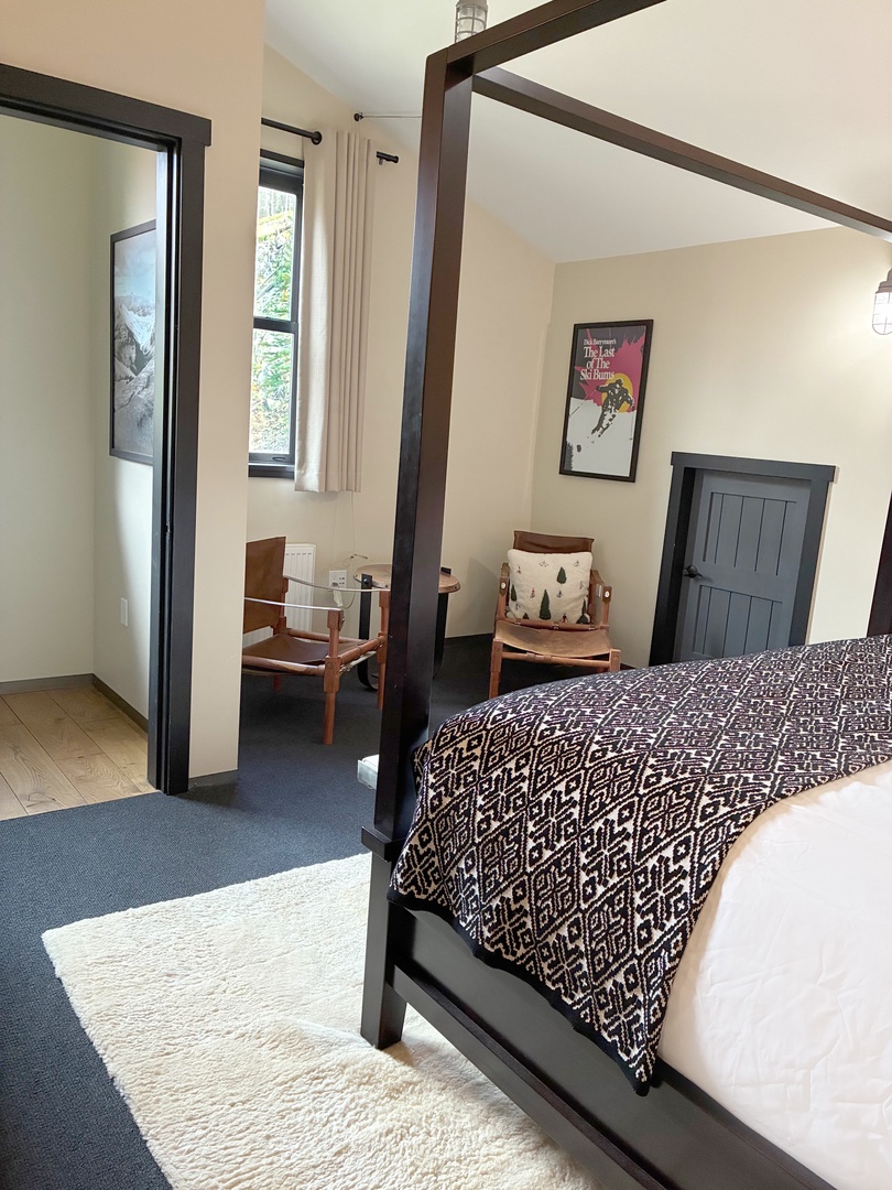Settle into your peaceful retreat where modern style meets cozy comfort. The four-poster bed invites restful sleep while natural light and thoughtful design create a calming atmosphere for your getaway.