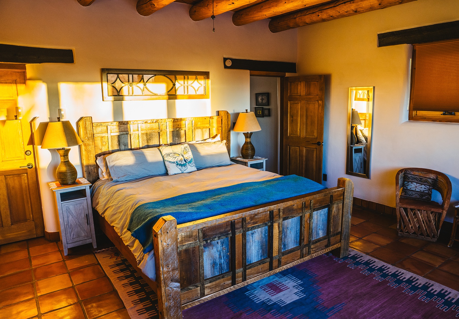 Unwind in your rustic-chic bedroom with exposed beams and handcrafted furnishings creating a warm, authentic atmosphere.