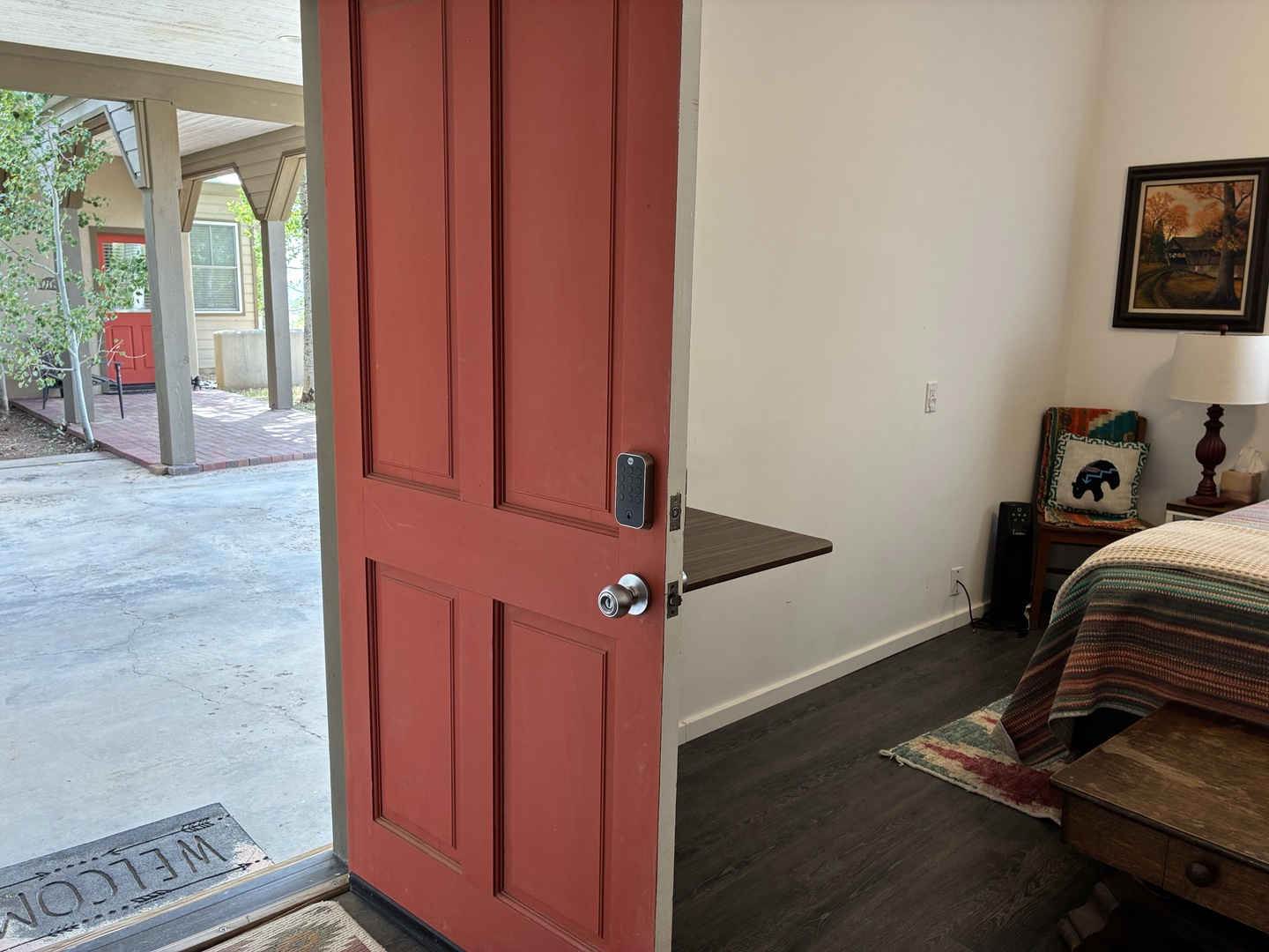 Step inside your cozy bedroom where thoughtful touches await. The warm space opens to a covered patio, blending indoor comfort with outdoor charm—perfect for your peaceful getaway.