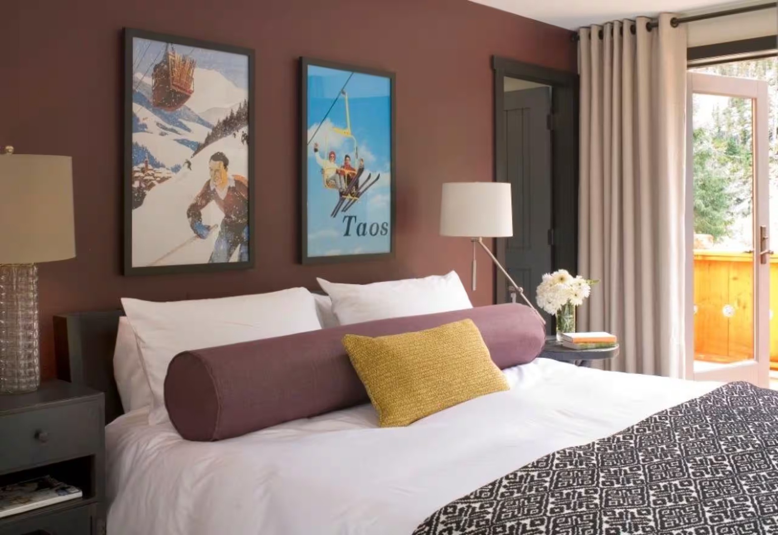 Sink into plush bedding and let the mountain-inspired decor transport you. Your private balcony awaits, framed by soft curtains and daylight.