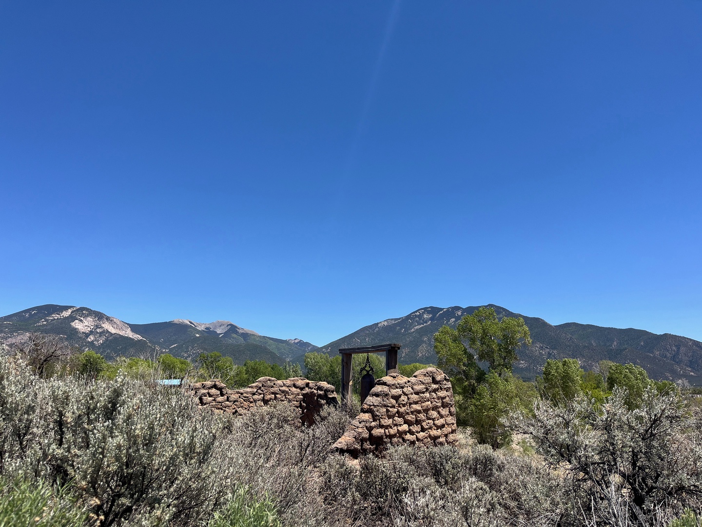 Historic adobe ruins stand against a dramatic mountain backdrop, offering guests a glimpse into the area's rich cultural heritage and natural beauty.