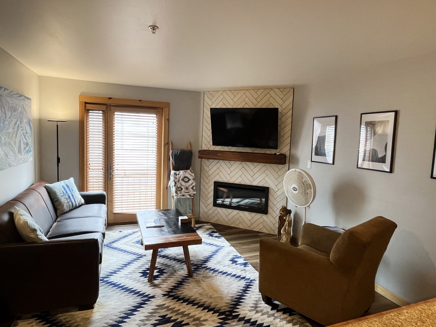 Unwind in your bright, modern living room with a cozy fireplace, smart TV, and stylish seating—the perfect retreat after a day in the mountains