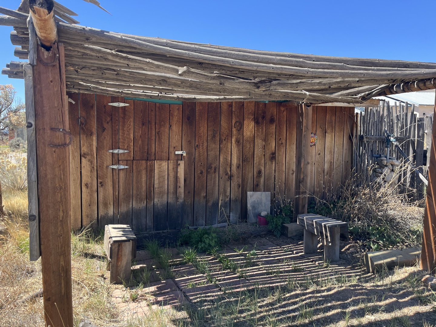 Rustic desert building with weathered wood construction and natural surroundings.