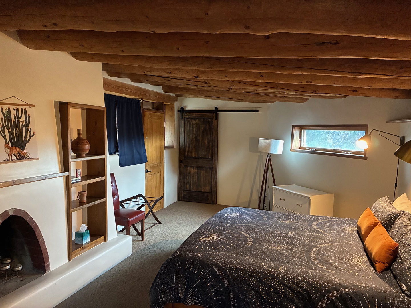Relax under rustic wood-beamed ceilings in your cozy bedroom, complete with a charming kiva fireplace and warm southwestern touches that make this space uniquely yours.