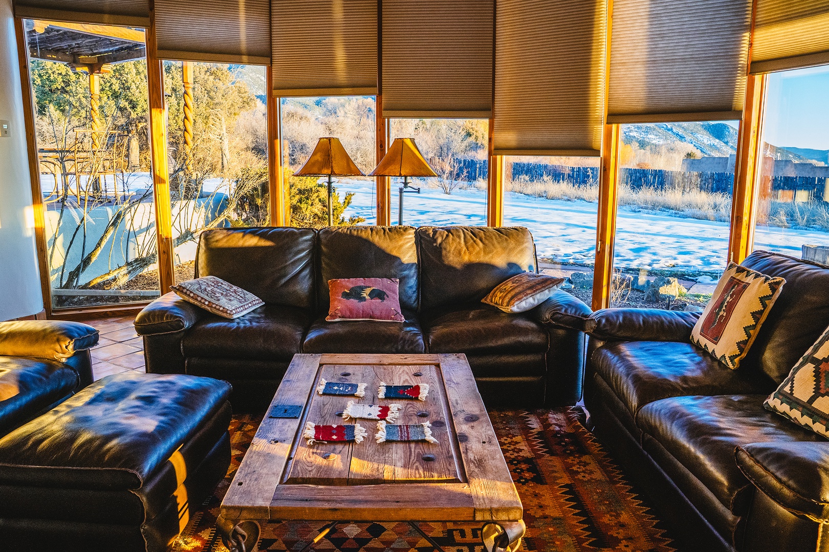 Sink into plush leather seating as golden sunlight filters through your panoramic windows, revealing stunning winter vistas that make every moment feel magical.