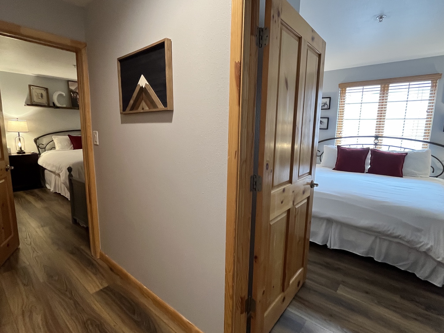 Two cozy bedrooms connected by hallway.