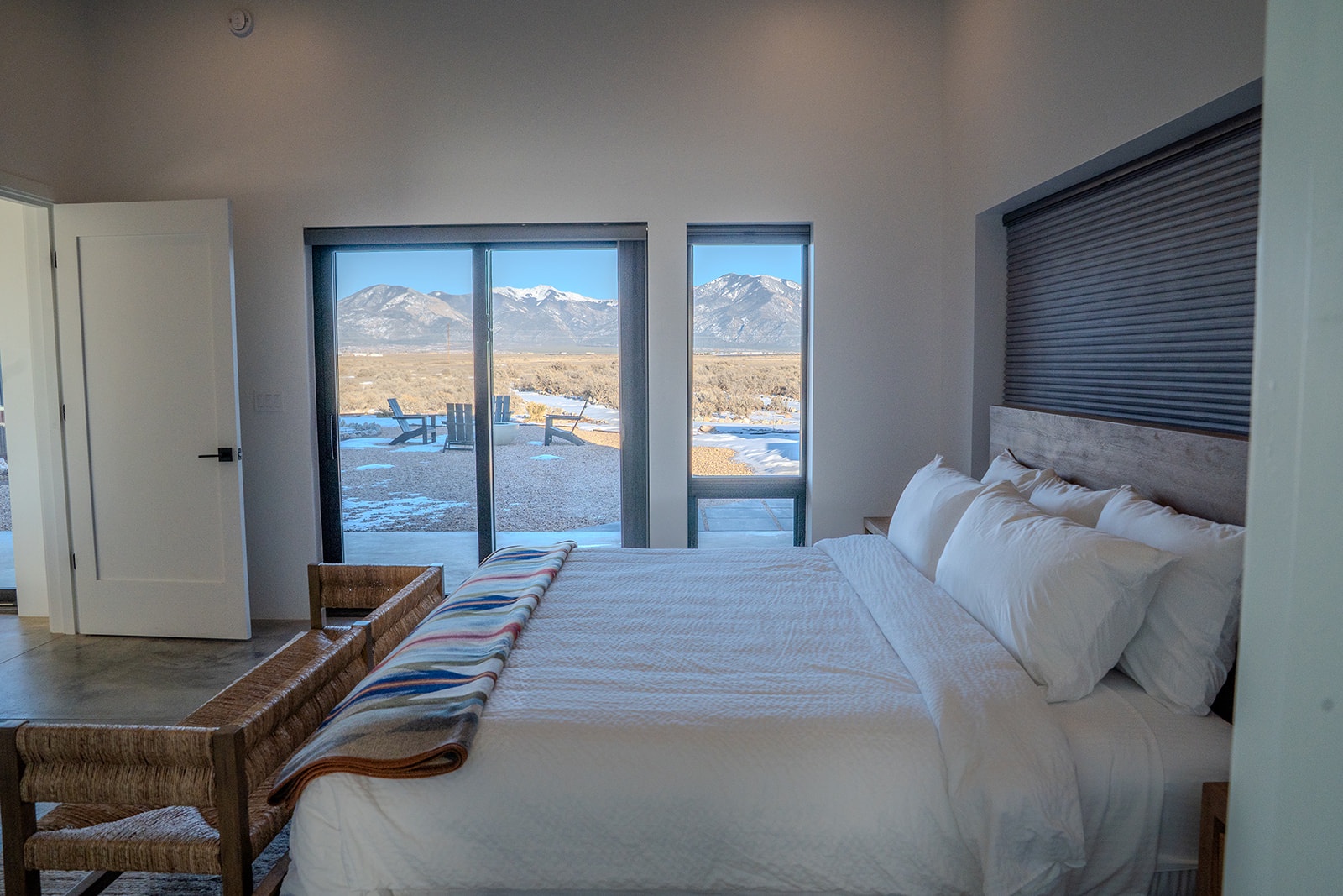 Wake up to breathtaking mountain views from your comfortable bed, where crisp white linens meet stunning alpine panoramas.