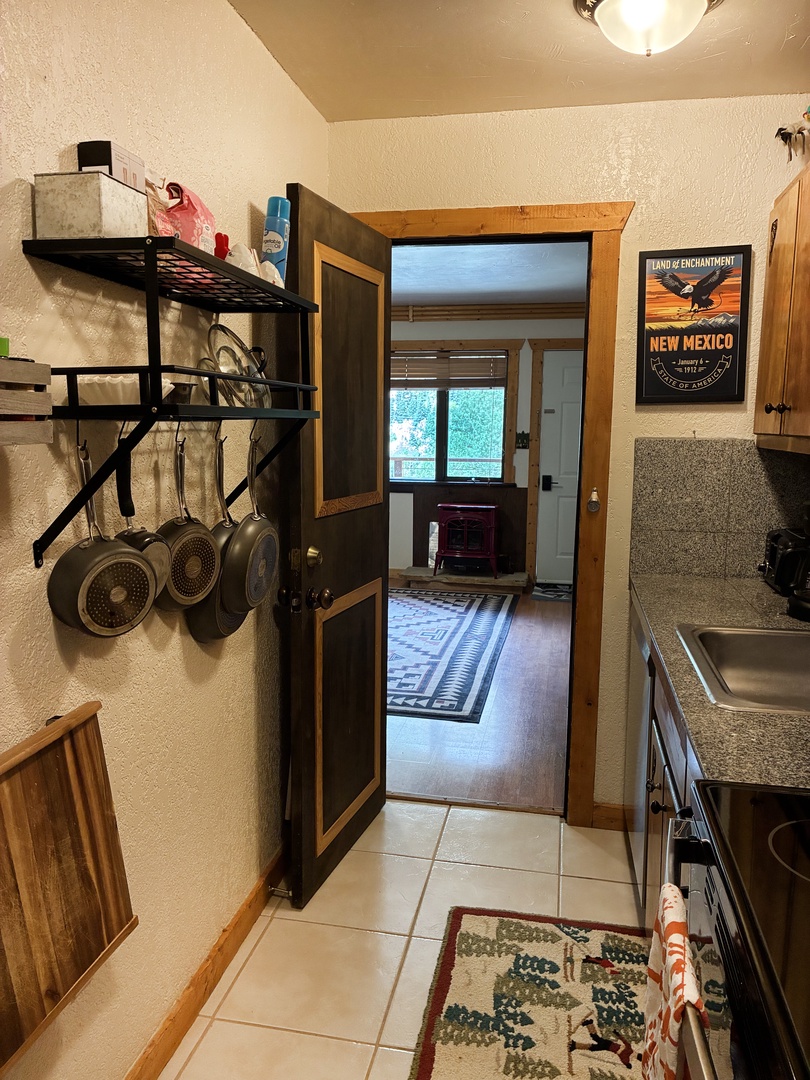 Full kitchen in a galley layout means meal prep is easy and contained between the two private sleeping spaces.