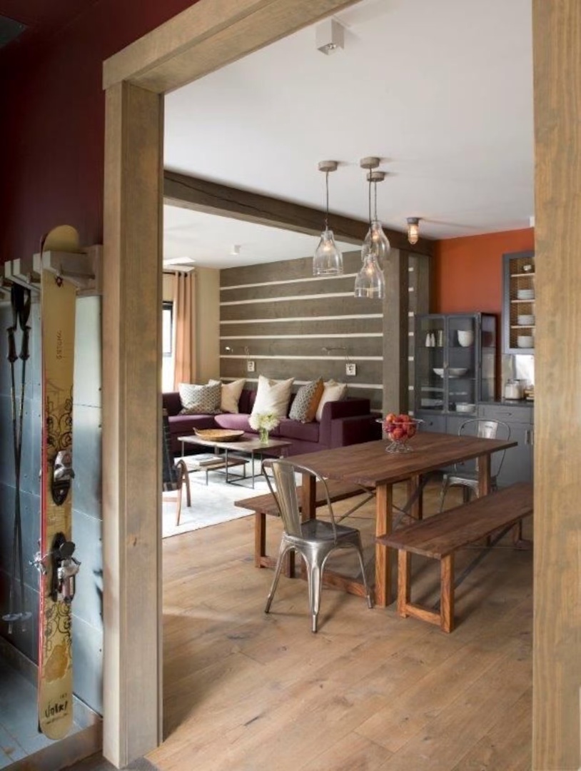 Step into your inviting open-concept living and dining space, where warm wood tones and vibrant accent walls create a welcoming atmosphere for relaxing and gathering with loved ones.