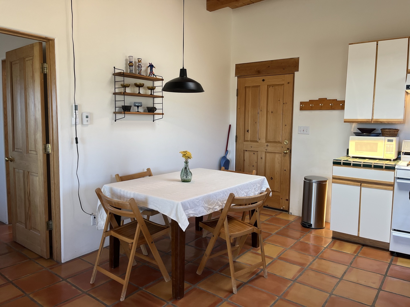 Gather around your cozy dining table with rustic charm, featuring warm wood furniture and a striking pendant light for memorable meals.