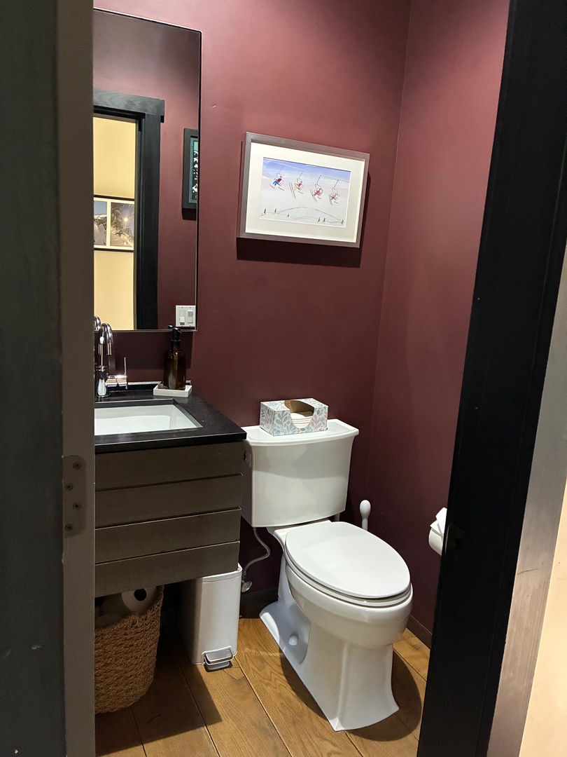 Step into a cozy powder room with warm, inviting tones and clean, modern fixtures ready for your use.