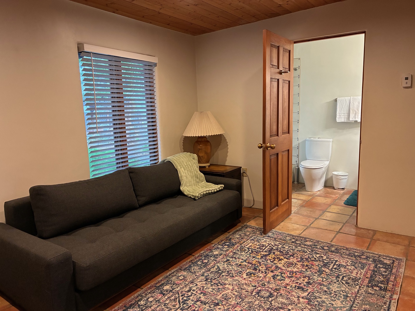 Settle into your cozy living space with wood-paneled warmth and private ensuite convenience just steps away.