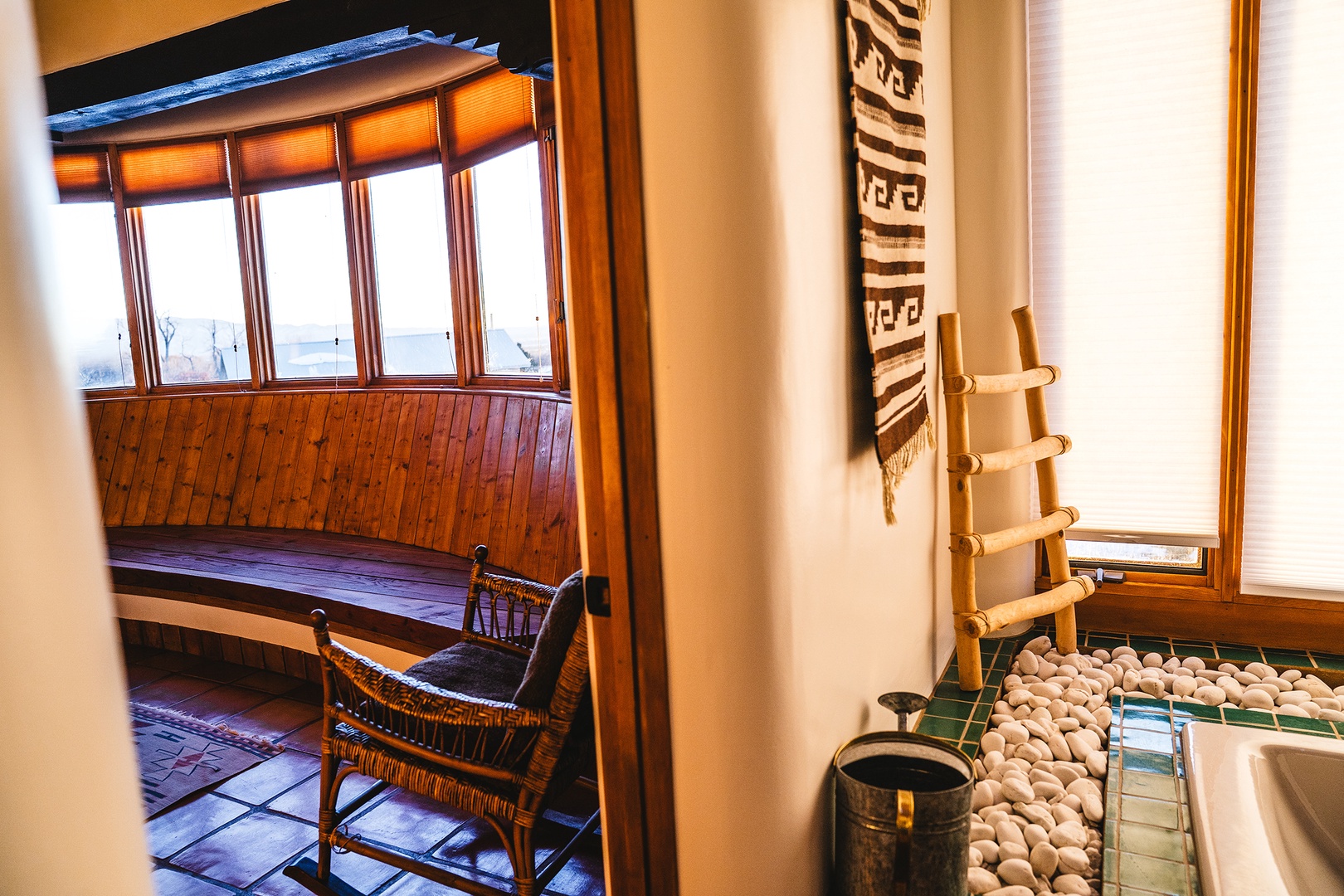 Unwind in your cozy seating nook with authentic southwestern charm, featuring handcrafted furniture and warm natural light streaming through traditional windows.