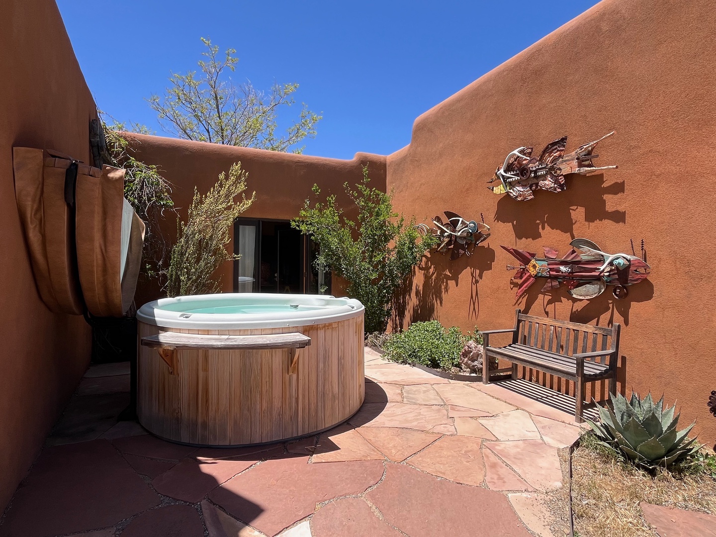 Soak in the hot tub under clear blue skies!