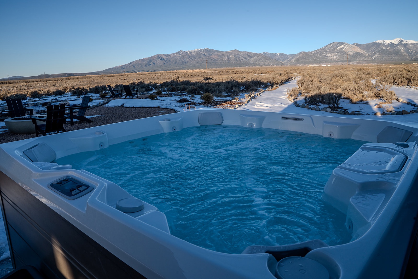 Soak in your private hot tub while gazing at snow-capped mountains stretching across the desert horizon.