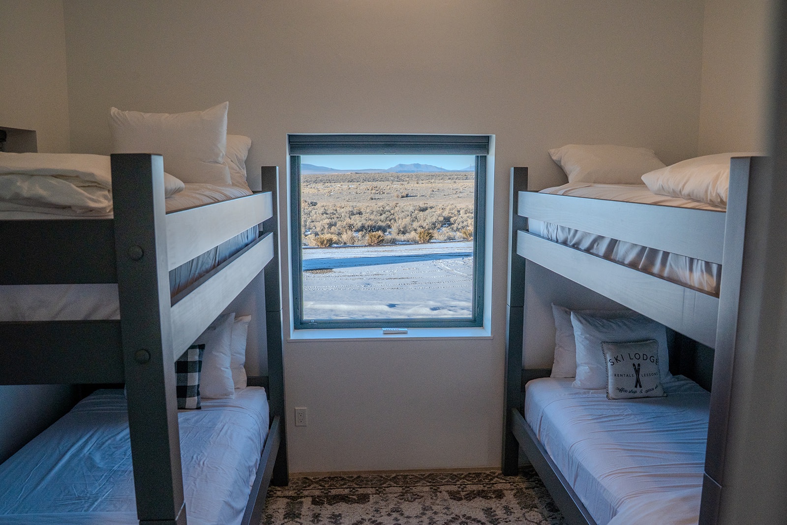 Rest peacefully in your cozy bunk beds while gazing at stunning mountain vistas through your private window.