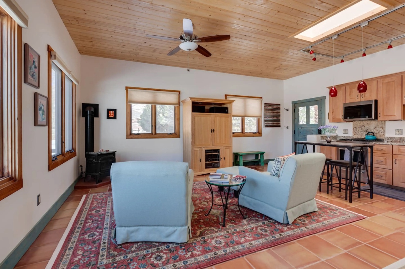 Gather around the cozy seating area or fix a quick meal at the breakfast bar—your open-concept living space invites you to relax under natural light streaming through skylights and windows.