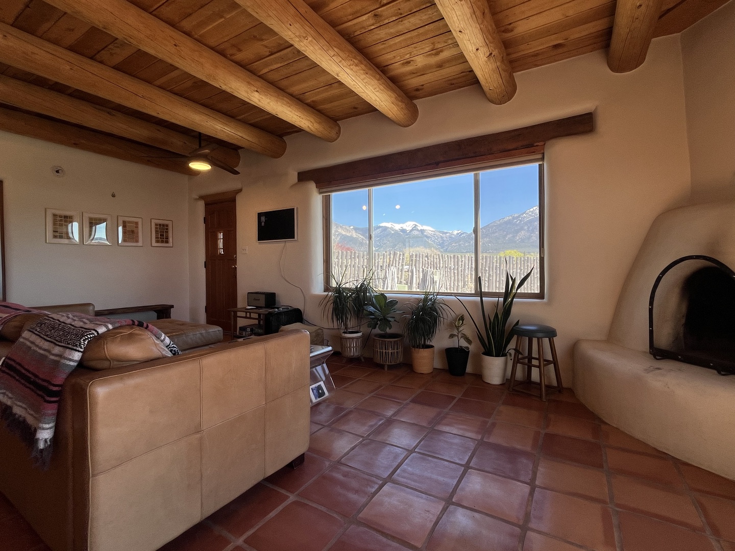 Unwind in your living room where rustic beams meet modern comfort, with stunning mountain views framing your peaceful retreat.