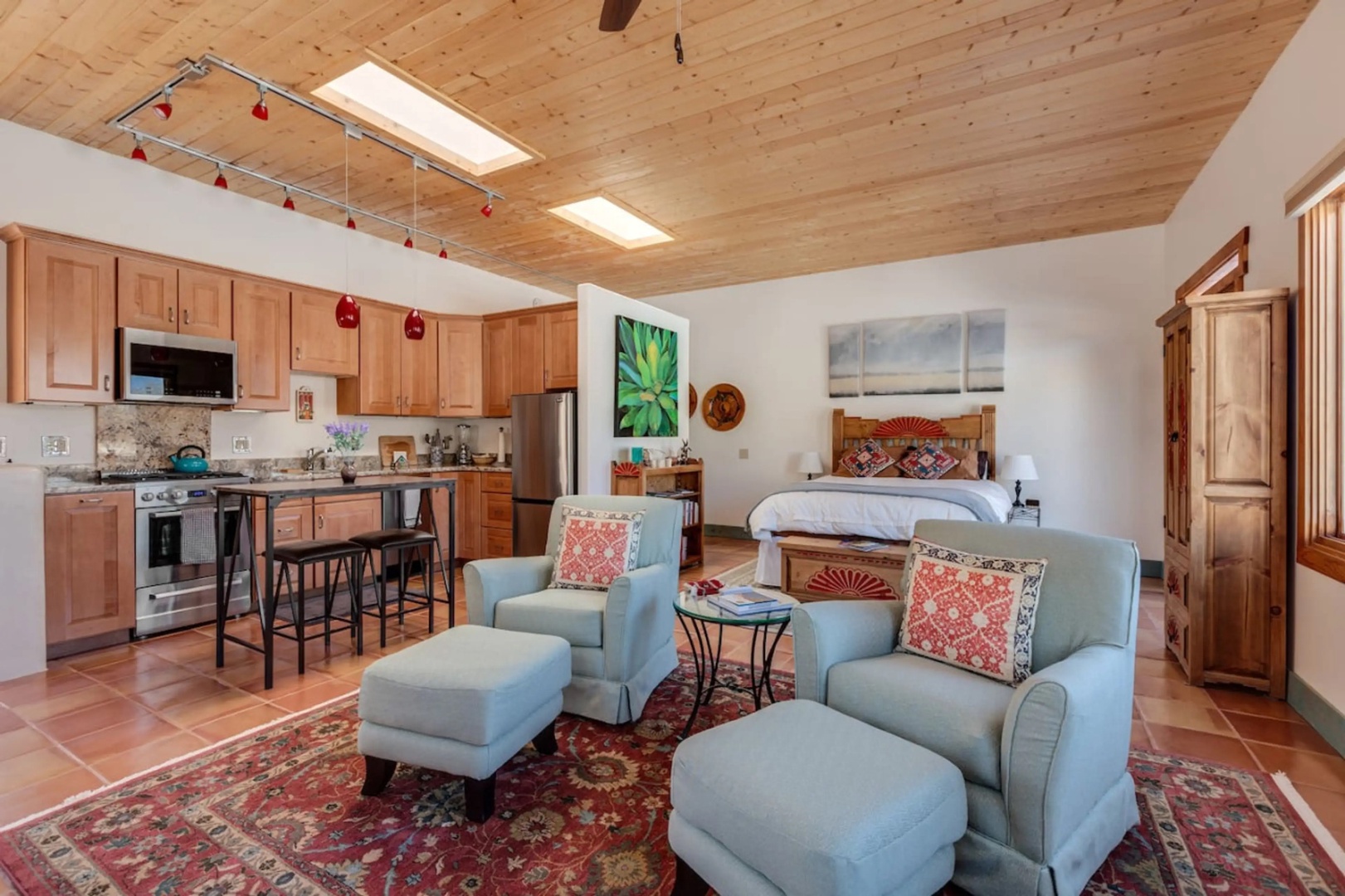 Unwind in your bright, open studio with soaring wood ceilings and skylights. Your full kitchen, cozy living space, and comfortable bed all come together in one inviting retreat.