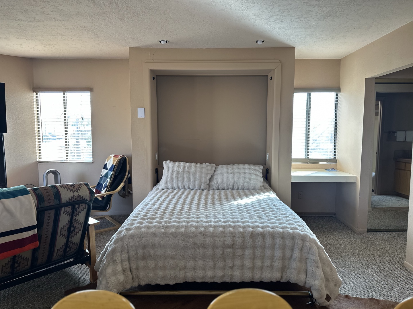 Your spacious retreat features a Murphy bed that effortlessly transforms this bright, airy room from living space to bedroom.