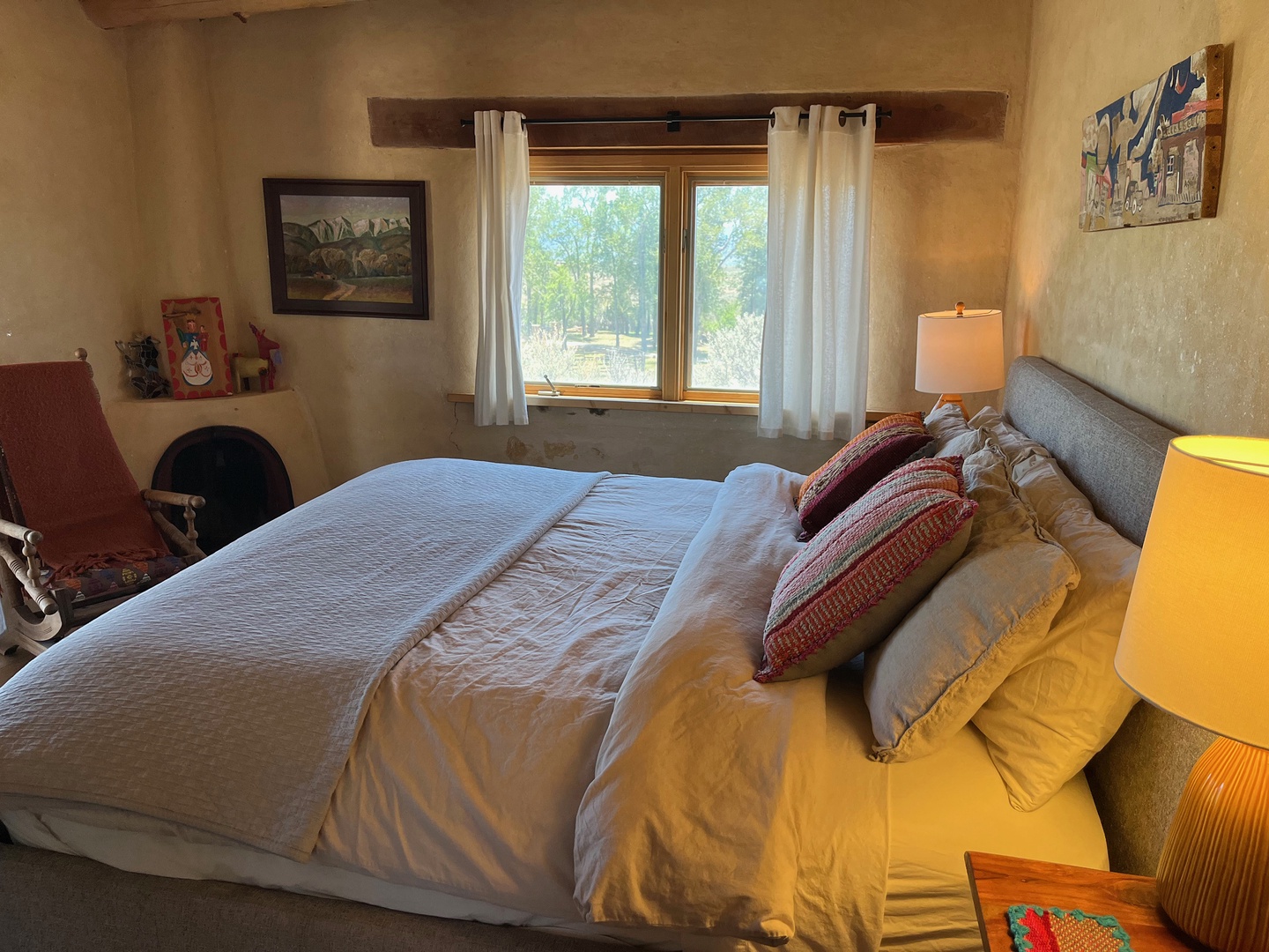 Your cozy bedroom invites restful nights with a plush bed, warm Southwest touches, and views of the tranquil landscape beyond your window.