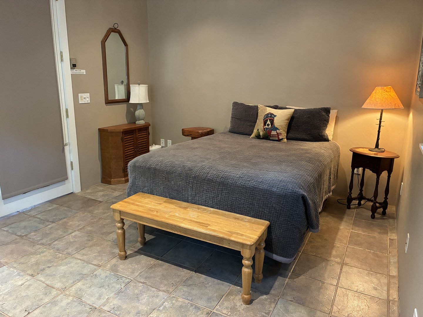 Unwind in your spacious bedroom with cozy textured bedding, warm ambient lighting, and charming rustic touches that create a peaceful retreat after a day of adventure.